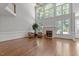 Bright living room features a fireplace, hardwood floors, and large windows at 312 Flint Point Ln, Holly Springs, NC 27540