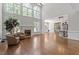 Expansive living room with fireplace, hardwood floors, and natural light, seamlessly connecting to the kitchen at 312 Flint Point Ln, Holly Springs, NC 27540