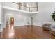 Spacious living room with gleaming hardwood floors, neutral paint, and a grand staircase at 312 Flint Point Ln, Holly Springs, NC 27540