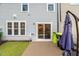 View of the home's backyard featuring a cement patio, lawn, and sliding glass door into the home at 3215 Retama, New Hill, NC 27562