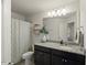 Bathroom featuring a granite countertop vanity, modern lighting, and a shower with a curtain at 3215 Retama, New Hill, NC 27562