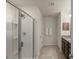 Clean bathroom featuring a glass-enclosed shower and a dark vanity sink at 3215 Retama, New Hill, NC 27562