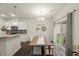 Open dining area with wood table, chandelier, sliding door to yard and adjacent kitchen at 3215 Retama, New Hill, NC 27562