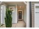 Inviting entryway with neutral walls, a dark wood door, and a welcoming doormat at 3215 Retama, New Hill, NC 27562