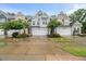 Charming townhome exteriors with manicured lawns, gardens and attached garages offer curb appeal at 3215 Retama, New Hill, NC 27562