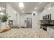 The kitchen features granite counters, stainless appliances, white cabinets and modern lighting fixtures at 3215 Retama, New Hill, NC 27562