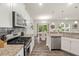 Bright kitchen featuring stainless steel appliances, granite countertops and views to the dining area at 3215 Retama, New Hill, NC 27562