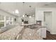 Bright kitchen features granite countertops, stainless steel sink and appliances, and pendant lighting at 3215 Retama, New Hill, NC 27562