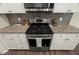 Modern kitchen featuring a gas range, granite countertops, and subway tile backsplash at 3215 Retama, New Hill, NC 27562