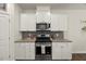 Modern kitchen featuring stainless steel appliances, granite countertops, gas range and white cabinetry at 3215 Retama, New Hill, NC 27562