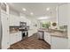 Modern kitchen featuring stainless steel appliances, granite countertops and white cabinetry at 3215 Retama, New Hill, NC 27562