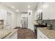 Modern kitchen featuring stainless steel appliances, granite countertops and white cabinetry at 3215 Retama, New Hill, NC 27562