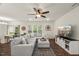 Bright open-concept living area features a comfortable sectional sofa, stylish decor, and plenty of light at 3215 Retama, New Hill, NC 27562
