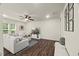 Bright living room featuring a large sectional sofa, television and a decorative ceiling fan at 3215 Retama, New Hill, NC 27562