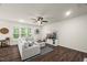 Inviting living room with a cozy sectional sofa, modern TV, and dark wood-look floors at 3215 Retama, New Hill, NC 27562