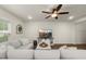 Bright, comfortable living room with a sectional sofa, sleek TV, and cozy decor elements at 3215 Retama, New Hill, NC 27562