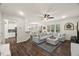 Bright living room featuring dark floors, a large sectional sofa, and open concept design at 3215 Retama, New Hill, NC 27562