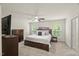 Spacious main bedroom with neutral colors, ceiling fan, and carpeted flooring at 3215 Retama, New Hill, NC 27562