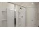 Modern glass shower displaying bright tiles, shelving, and updated shower head at 3215 Retama, New Hill, NC 27562