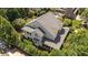 Aerial view of the house highlighting the lush landscaping and privacy provided by mature trees at 3306 Storybook Ln, Raleigh, NC 27614