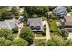 Aerial view of a home with well-maintained landscaping, a large driveway, and mature trees at 3306 Storybook Ln, Raleigh, NC 27614