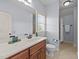Neutral bathroom with a window and a vanity with wood drawers and a white countertop at 3306 Storybook Ln, Raleigh, NC 27614