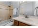 Classic bathroom featuring a tiled shower-tub and a wood vanity with a white countertop at 3306 Storybook Ln, Raleigh, NC 27614