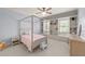 Light-filled bedroom with a four-poster bed, built-in bookshelves, and a neutral color scheme at 3306 Storybook Ln, Raleigh, NC 27614