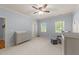 Bright Bedroom featuring neutral walls, carpet, and a ceiling fan; well-lit by two windows at 3306 Storybook Ln, Raleigh, NC 27614