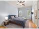 Cozy bedroom with a ceiling fan, two windows, and hardwood floors at 3306 Storybook Ln, Raleigh, NC 27614