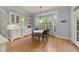 Bright breakfast nook with a round table, bay windows, and custom cabinetry for casual dining at 3306 Storybook Ln, Raleigh, NC 27614