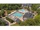 Aerial view of the community pool area with multiple pools, a slide, and ample seating at 3306 Storybook Ln, Raleigh, NC 27614