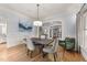 Well-lit dining room with hardwood floors and neutral color palette, adjacent to an office at 3306 Storybook Ln, Raleigh, NC 27614