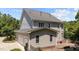 Exterior view of the home features light gray siding, a gray roof, and a two-car garage at 3306 Storybook Ln, Raleigh, NC 27614