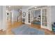 Elegant foyer featuring hardwood floors, staircase, and arched doorway to the office at 3306 Storybook Ln, Raleigh, NC 27614