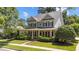 Beautiful two-story home with a wrap-around porch, mature landscaping, and inviting curb appeal at 3306 Storybook Ln, Raleigh, NC 27614