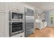 Kitchen featuring stainless steel appliances, sleek white cabinetry, and built-in double ovens for the at-home chef at 3306 Storybook Ln, Raleigh, NC 27614