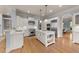 Bright kitchen featuring stainless steel appliances, white cabinets, and a center island at 3306 Storybook Ln, Raleigh, NC 27614