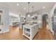 Open kitchen with a central island, stainless steel appliances, and seamless flow to the adjacent living area at 3306 Storybook Ln, Raleigh, NC 27614
