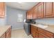 Functional laundry room with ample counter space, cabinets, and a window for natural light at 3306 Storybook Ln, Raleigh, NC 27614