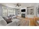 Inviting living room featuring built-in bookshelves, a fireplace, and lots of natural light at 3306 Storybook Ln, Raleigh, NC 27614