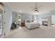 Spacious main bedroom with a fireplace, two windows, a ceiling fan, and access to the balcony at 3306 Storybook Ln, Raleigh, NC 27614