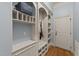 Mudroom features built-in storage, shelving, a bench, and coat hooks near the entry door at 3306 Storybook Ln, Raleigh, NC 27614