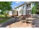 Backyard patio with room for outdoor dining and stairs up to a screened porch at 3306 Storybook Ln, Raleigh, NC 27614