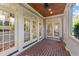 Covered patio with brick flooring, ceiling fan, and views into the home at 3306 Storybook Ln, Raleigh, NC 27614