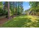 Lush backyard with mature trees and a serene, secluded atmosphere at 3317 Harden Rd, Raleigh, NC 27607