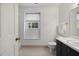 Bathroom with hexagon tile, tub shower, dark vanity and framed mirror at 3317 Harden Rd, Raleigh, NC 27607
