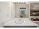 Well-lit bathroom featuring a dark vanity, framed mirror, and neutral decor at 3317 Harden Rd, Raleigh, NC 27607