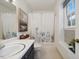 Bathroom featuring a shower/tub, modern vanity, and a framed mirror at 3317 Harden Rd, Raleigh, NC 27607