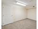 A finished room with neutral walls, carpet, and a door at 3317 Harden Rd, Raleigh, NC 27607